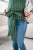 Modelka nosi dziecko w ergonomicznego nosidle KAVKA Handy fern braid bamboo- zielone nosidło z białym wzorem warkocza (green braid  with white braid pattern)